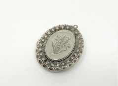 A Victorian engraved silver locket,