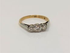 An 18ct gold three stone diamond ring, size M CONDITION REPORT: 2.