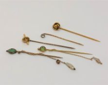 A group of five antique gold stick pins including two with pearl drops CONDITION REPORT: