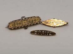 An antique gold 'baby' brooch together with two further similar brooches, 6.35g.