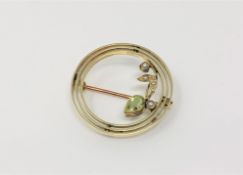 An Edwardian 15ct gold peridot and seed pearl brooch CONDITION REPORT: 3.