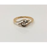 An 18ct gold solitaire diamond crossover ring, size K CONDITION REPORT: 2.