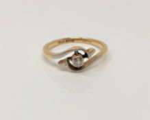 An 18ct gold solitaire diamond crossover ring, size K CONDITION REPORT: 2.