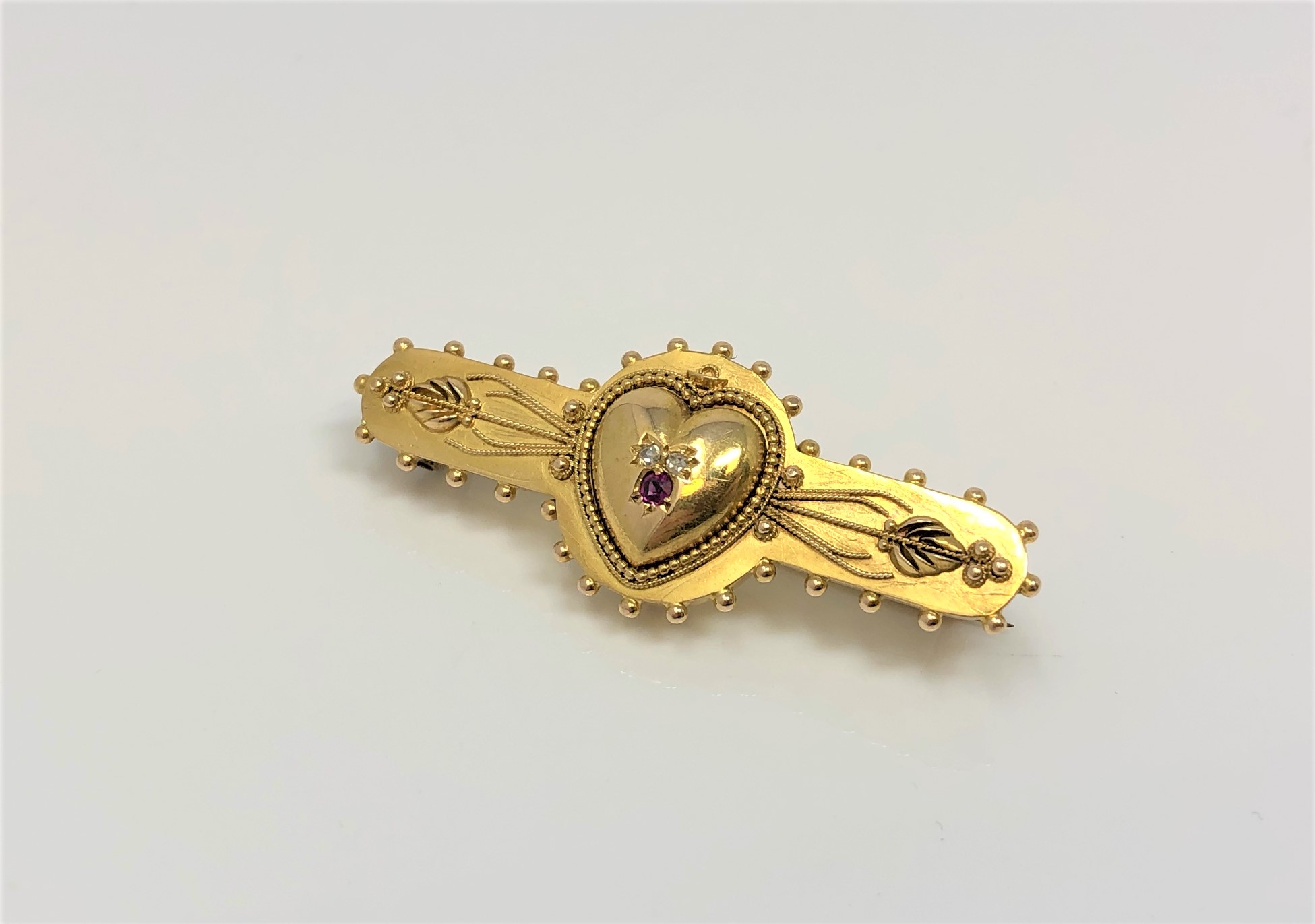 A 15ct gold brooch with central heart set with ruby and diamond CONDITION REPORT: 4.