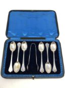 A boxed set of silver spoons and tongs,