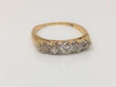 An antique gold five stone diamond ring, size O CONDITION REPORT: 3.8g. Marks worn.