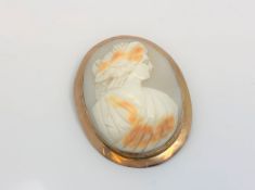 An antique rose-gold cameo brooch, 43 mm x 54 mm.