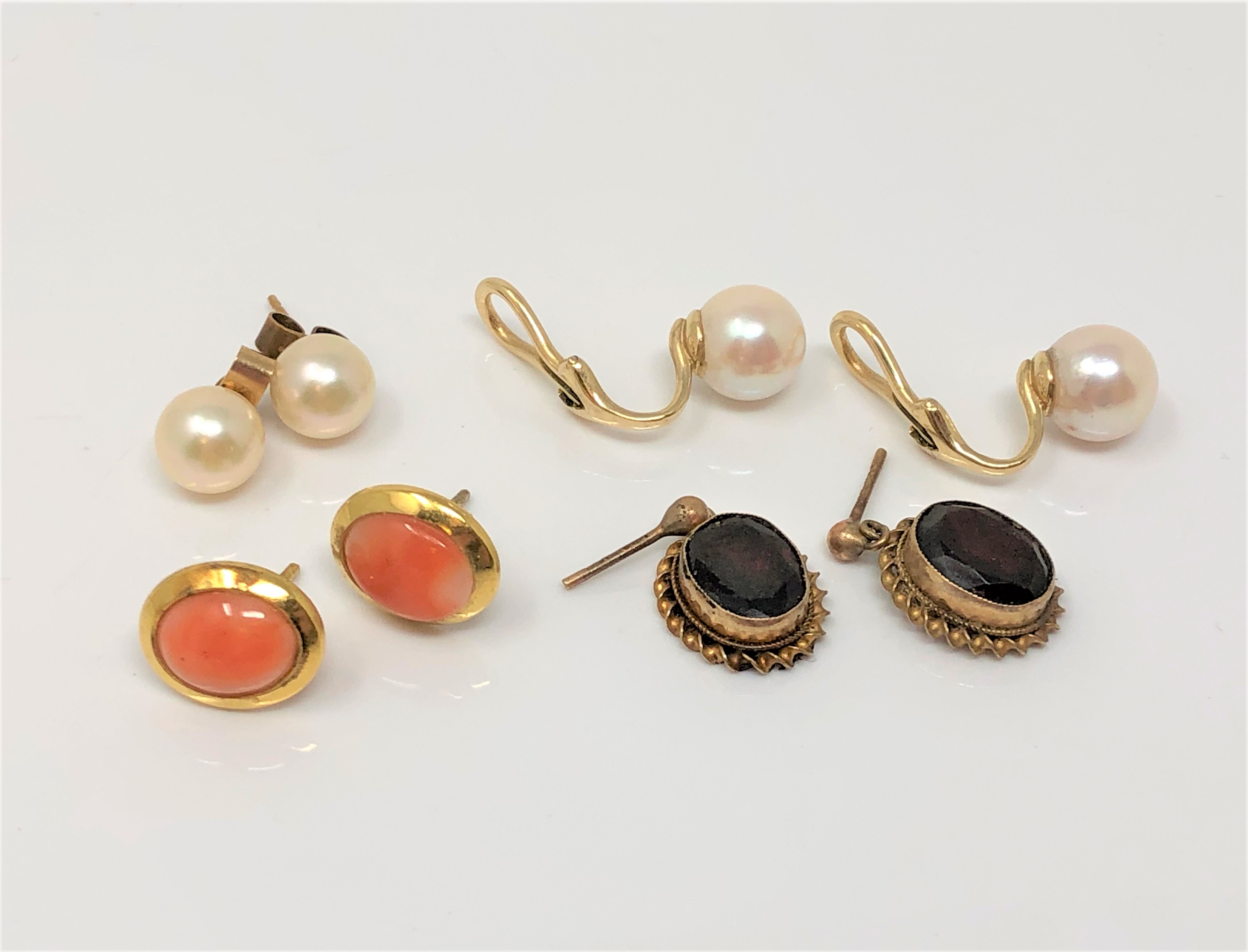 Four pairs of gold earrings set with pearls, coral and garnets.
