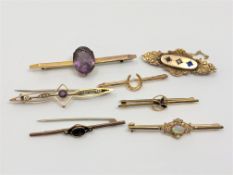 A group of seven gold brooches set with opal, amethyst, seed pearls,
