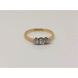 An 18ct gold and platinum three stone diamond ring, size O CONDITION REPORT: 1.