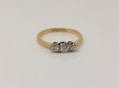 An 18ct gold and platinum three stone diamond ring, size O CONDITION REPORT: 1.