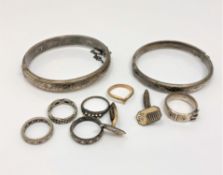 A group of jewellery comprising two silver bangles, silver buckle ring,