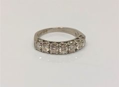 An 18ct white gold and platinum seven stone diamond half eternity ring,