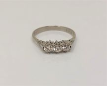 A platinum three stone diamond ring, size O CONDITION REPORT: 3.