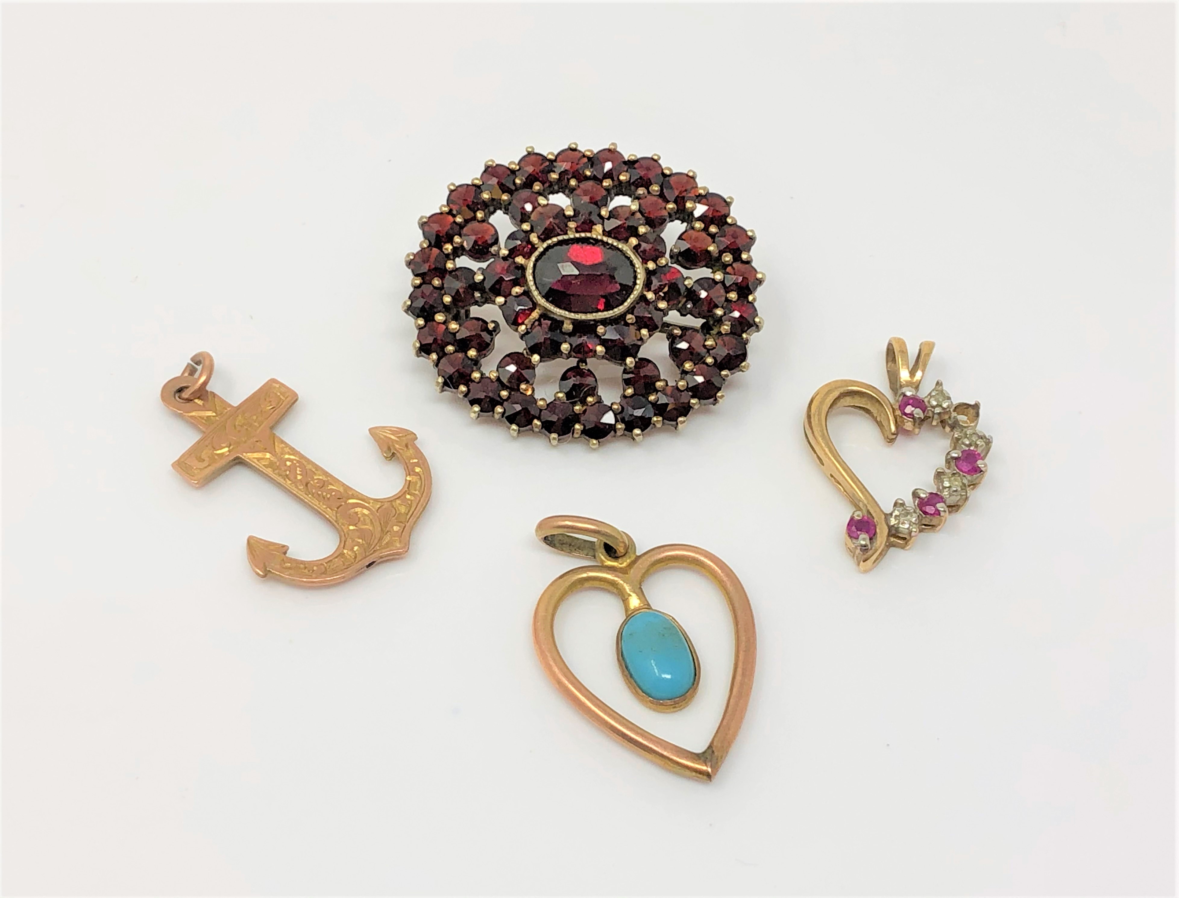 Two gold pendants set with turquoise/ruby and diamond, a gold anchor pendant and a gilt brooch.