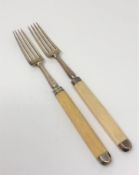 A pair of Georgian silver forks with ivory handles