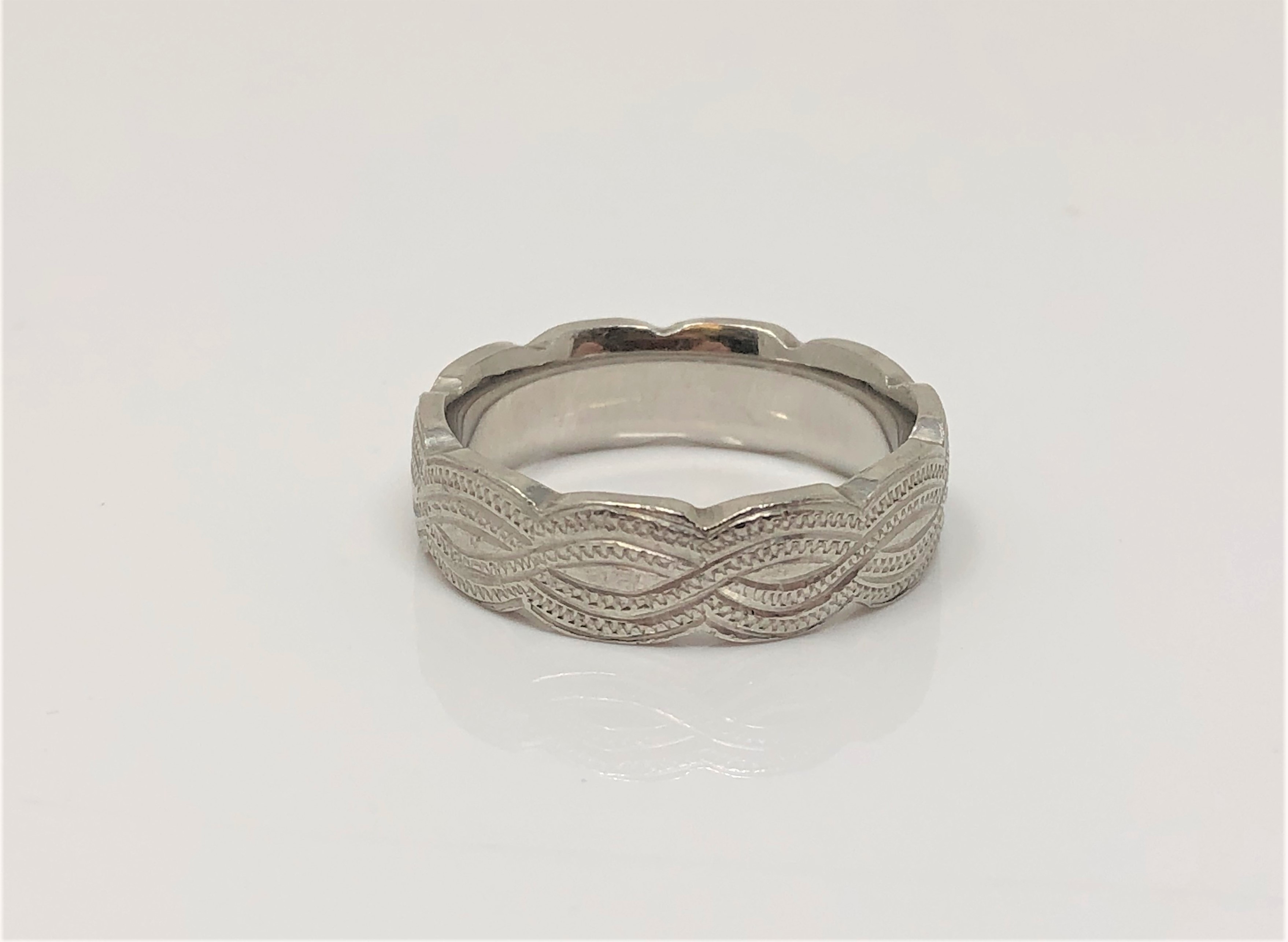 A heavy engraved platinum band ring, size P CONDITION REPORT: 12.