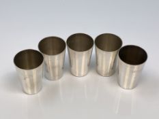 A set of silver miniature tumblers