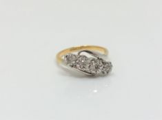 An 18ct gold and platinum four stone diamond ring,
