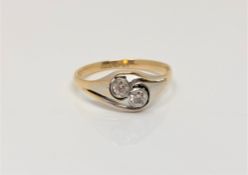 An 18ct gold and platinum two stone diamond ring, size P CONDITION REPORT: 2.