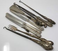 A group of silver mounted button hooks, silver handled knives,