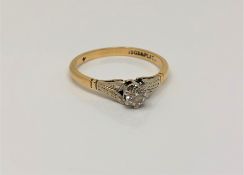 An 18ct gold and platinum solitaire diamond ring, approx 0.