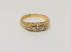 An 18ct gold three stone diamond ring, size J CONDITION REPORT: 3.