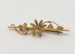 A gold bar brooch set with seed pearls CONDITION REPORT: The bar is stamped 15ct,