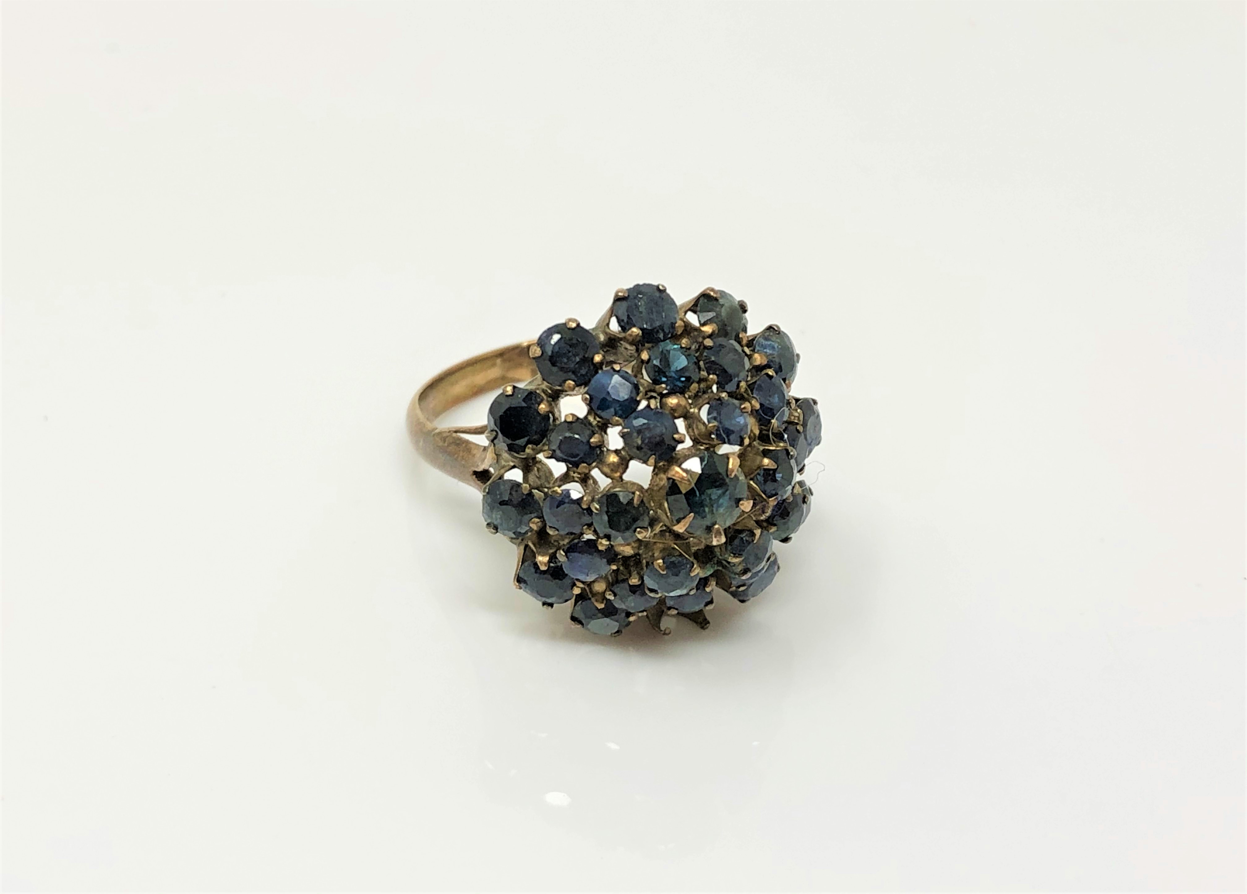 A 14ct gold sapphire cluster ring (one stone deficient),