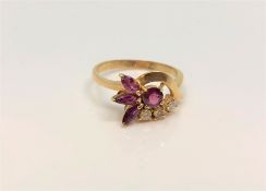 An 18ct gold ruby and diamond ring, size P/Q.
