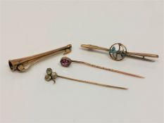 Four gold pins/brooches including hunting horn,