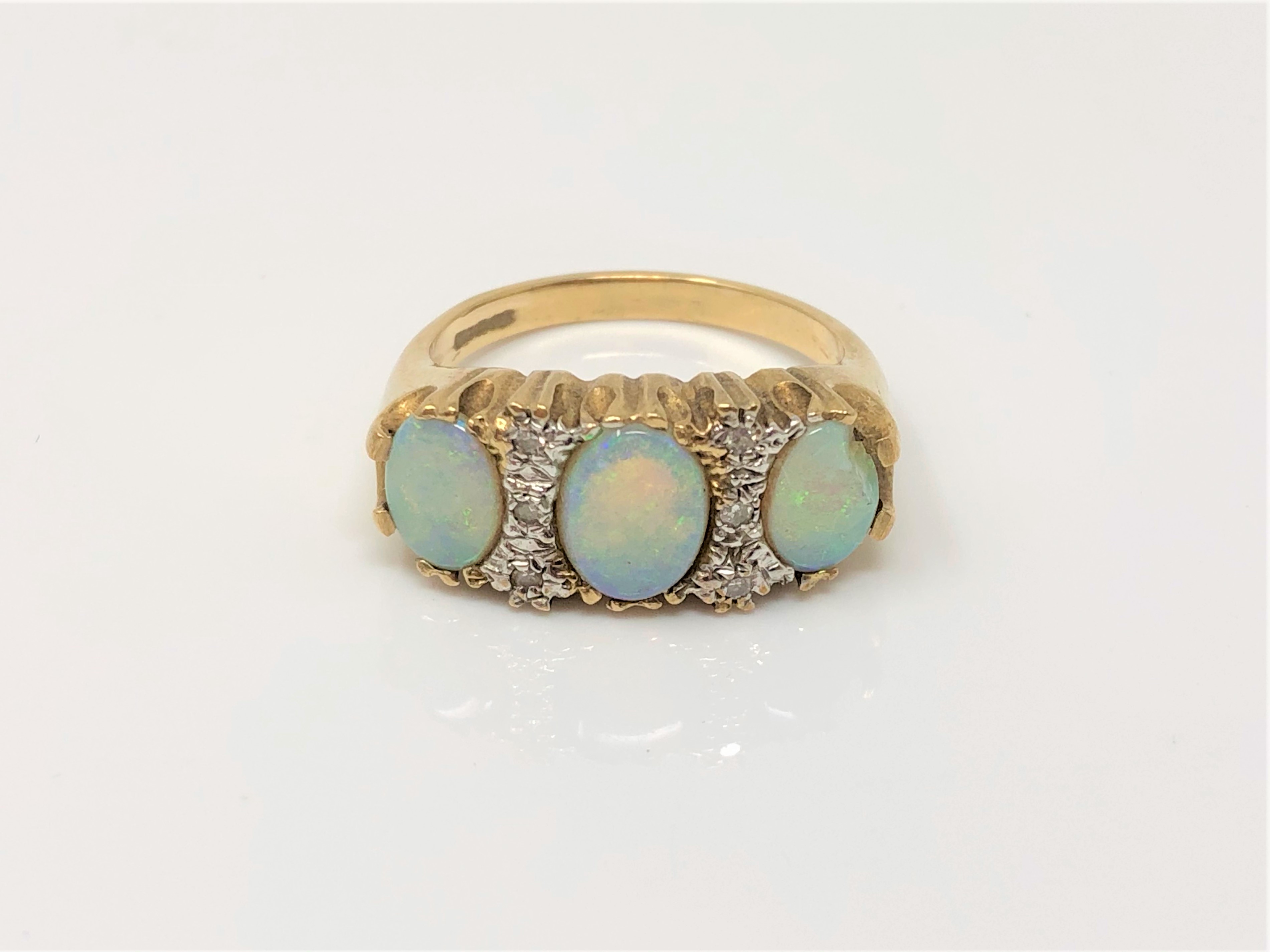 A 9ct gold opal and diamond ring (one opal chipped), size N CONDITION REPORT: 4.