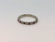 A platinum ruby and diamond half eternity ring,