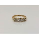 A fine Victorian 18ct gold ring dated 1888 to shank, set with five old cut diamonds,