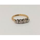 An 18ct gold and platinum four stone diamond ring, size N CONDITION REPORT: 2.