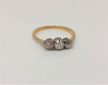 An antique 18ct gold three stone diamond ring, size O CONDITION REPORT: 1.