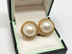 A pair of 18ct gold mabe pearl earrings.