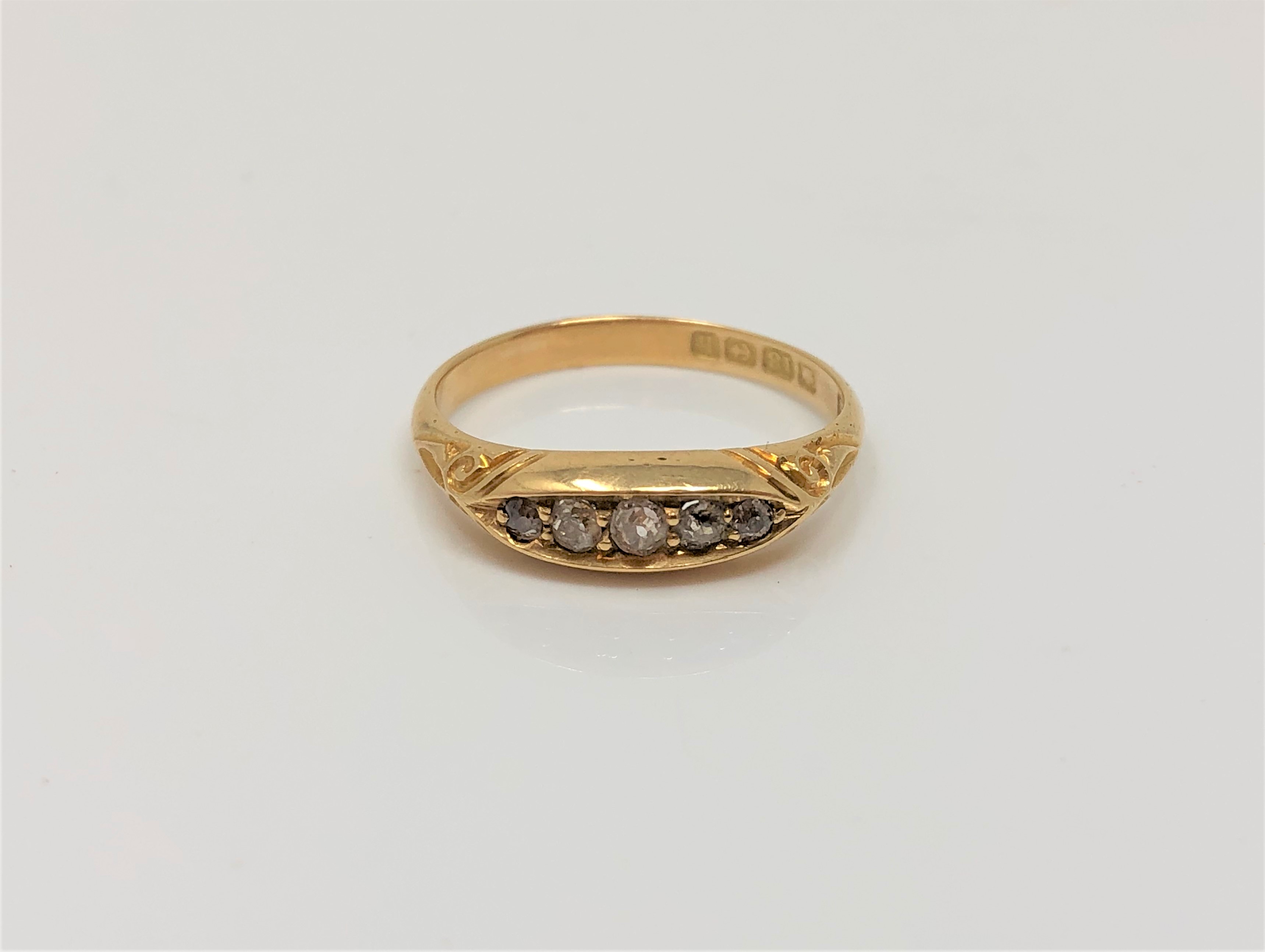 An 18ct gold five stone diamond ring, size M CONDITION REPORT: 2.