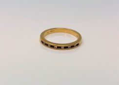 An 18ct gold sapphire and diamond half eternity ring, size N CONDITION REPORT: 2.