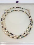 A cultured pearl necklace with 9ct rose gold clasp, strung with emerald,
