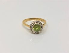 An 18ct gold peridot and diamond cluster ring, size N CONDITION REPORT: 3.
