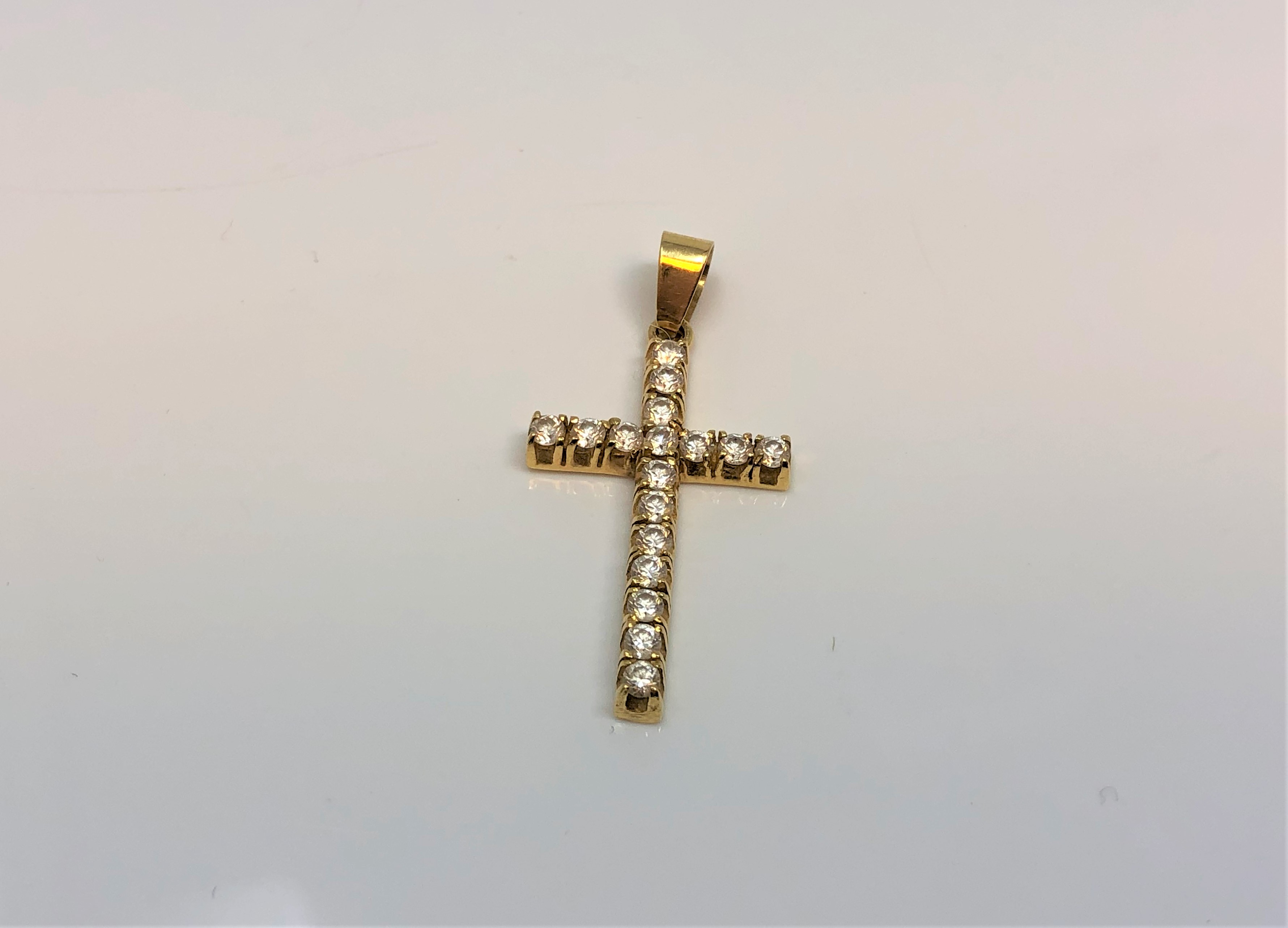 An 18ct yellow gold diamond cross pendant, the seventeen diamonds approximately 0.6ct.