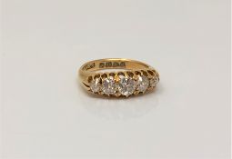 An 18ct gold five stone diamond ring, the total diamond weight approximately 1.