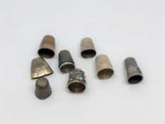 A group of four silver and other white metal thimbles