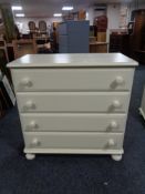 A painted pine four drawer chest with knob handles