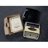 A cased Brother Deluxe typewriter and a box of sheet music