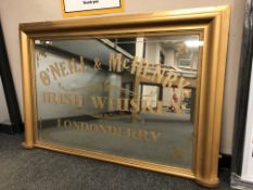 A gilt framed overmantel advertising mirror, O'Neill and McHenry, width 132 cm.