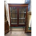 A late Victorian inlaid mahogany double door display cabinet fitted two drawers beneath,