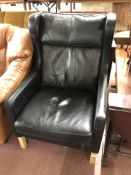 A 20th century Danish black leather wingback armchair