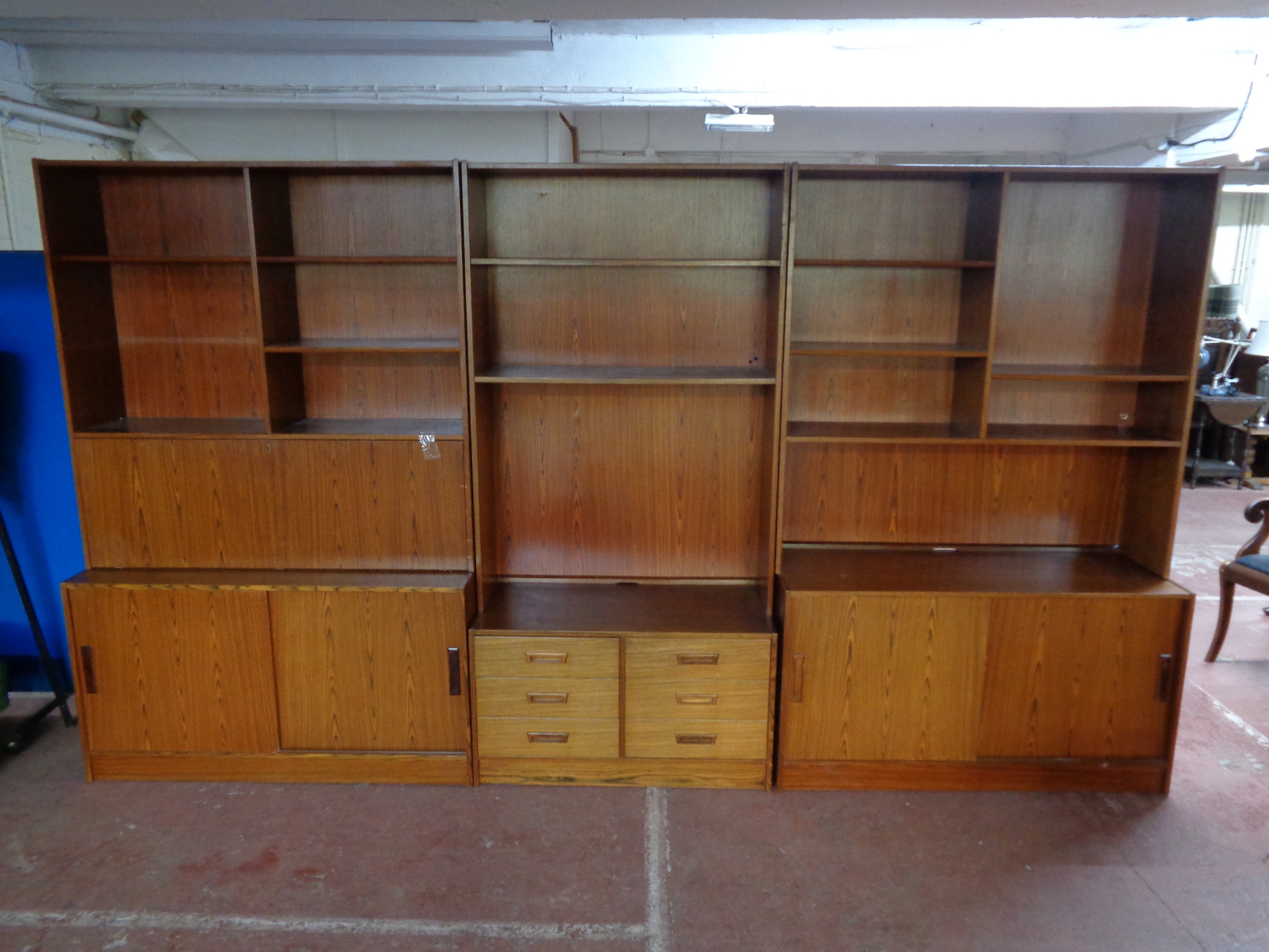 A mid 20th century three piece Danish bookcase fitted cupboards and drawers beneath